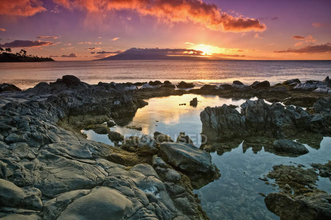 Sunset reflected in  tide pools — Stock Photo