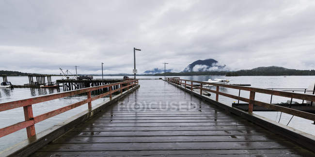 Wooden pier leading to docks in the harbour; Tofino, British Columbia, Canada — Stock Photo