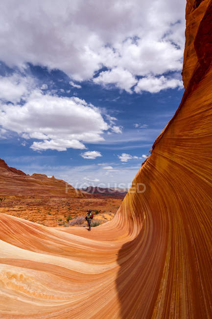 View of a hiker in sandstone formation — Stock Photo