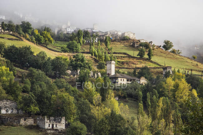 Village with towers over field — Stock Photo