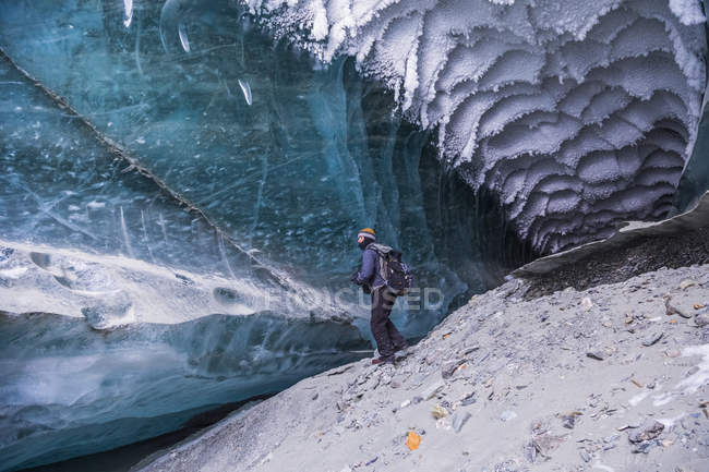 Man esplora il tunnel sotto il ghiaccio del ghiacciaio Canwell in Alaska Range in inverno, Alaska, Stati Uniti d'America — Foto stock