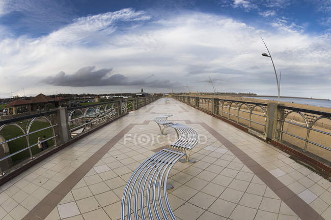 Curved bench on the promenade — Stock Photo
