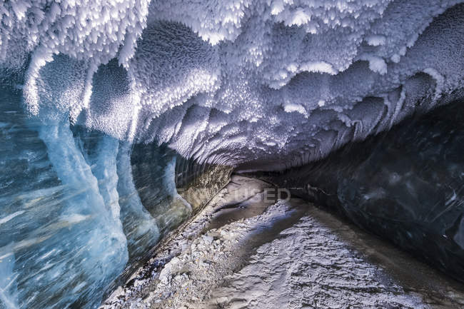 Ceiling of tunnel stretching beneath ice — Stock Photo