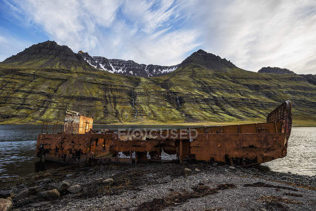Old shipwreck along water — Stock Photo