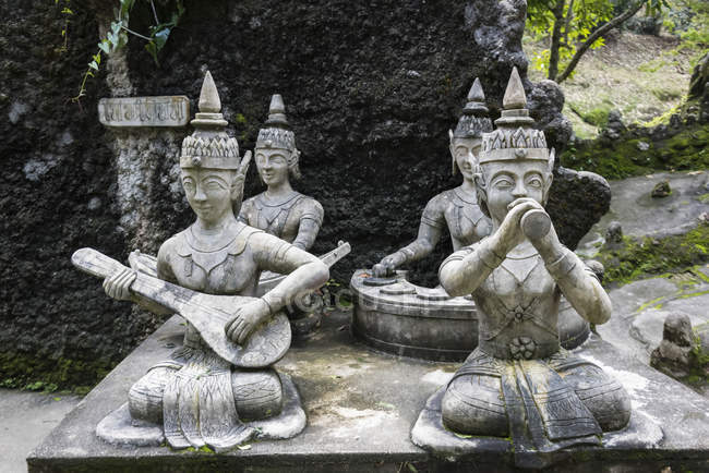 Buddhist statues playing musical instruments — Stock Photo