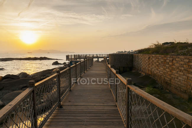 Wooden boardwalk with railing — Stock Photo