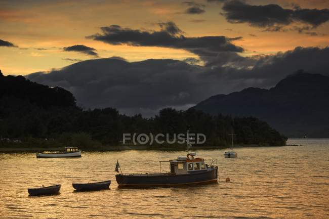 Boote bei Sonnenuntergang mit bewölktem Himmel — Stockfoto