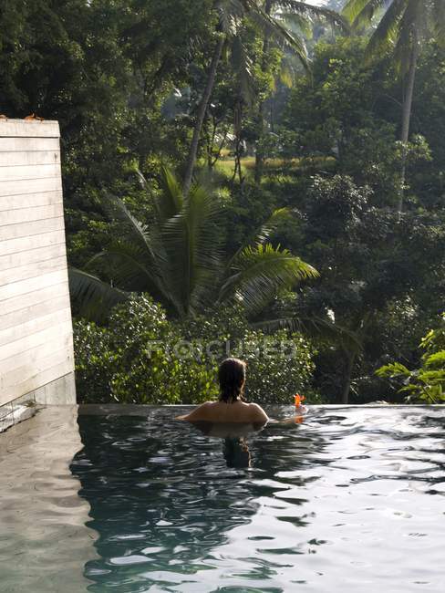 Rear View Of Woman In Pool. Bali Indonesia; — Stock Photo