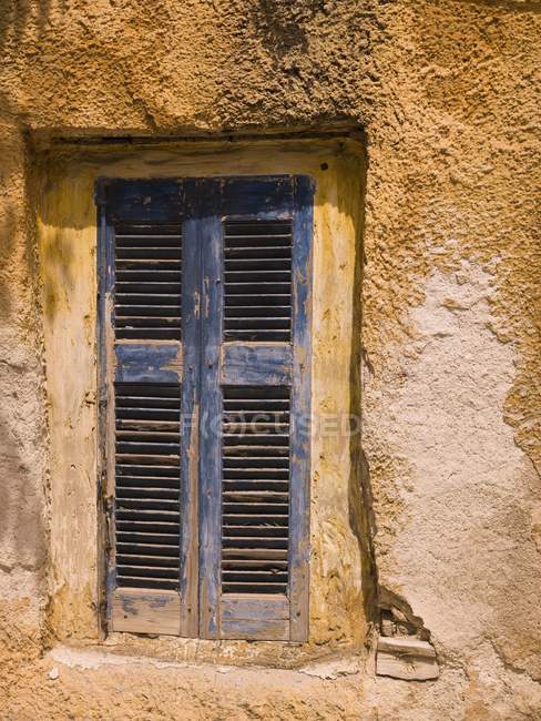 Weathered Window with shutters — Stock Photo