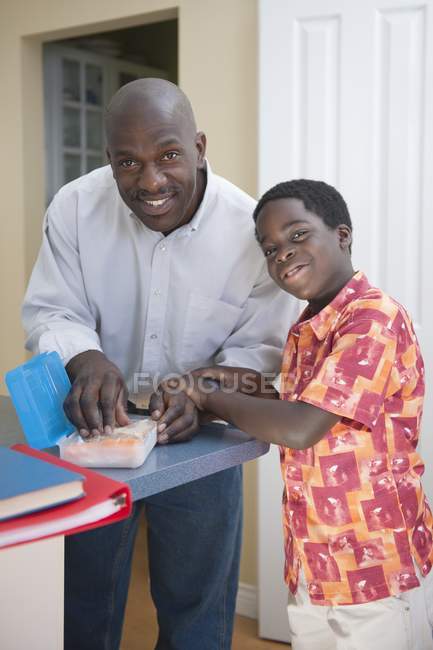 Father sending lunch with son to school — Stock Photo