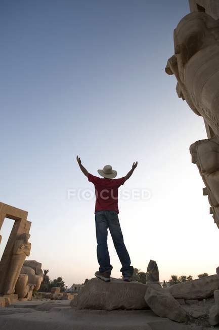 Man in hat with raised arms — Stock Photo