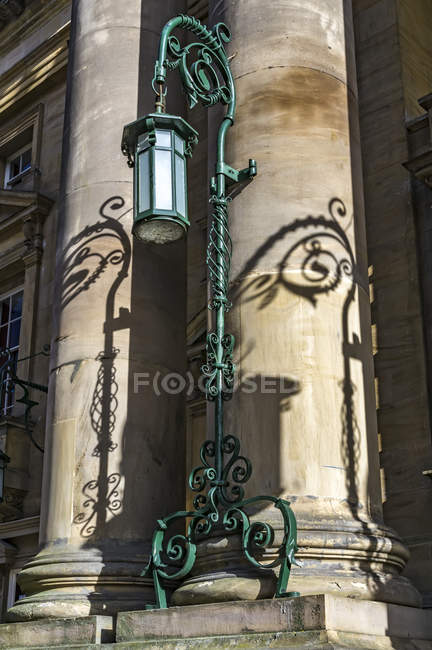 View of lighter on post  against columns on old building — Stock Photo