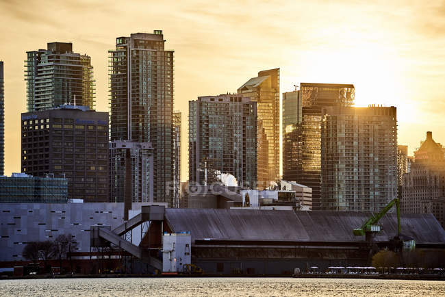 Condominios a lo largo del horizonte frente al mar al atardecer; Toronto, Ontario, Canadá - foto de stock