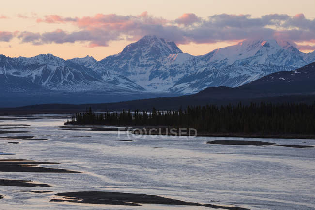 Mountain river with snow covered peaks on background — Stock Photo