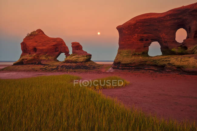 Arched rock formation on shore and sea water on background — Stock Photo