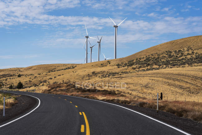 Wind turbines are found along a road in Gilliam County; Arlington, Oregon, United States of America — Stock Photo