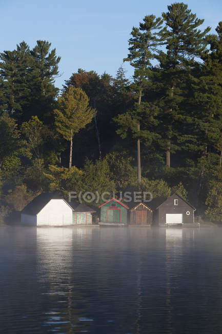 Cottage boathouses on Lake Rosseau in Ontario's Muskoka region; Rosseau, Ontario, Canada — Stock Photo