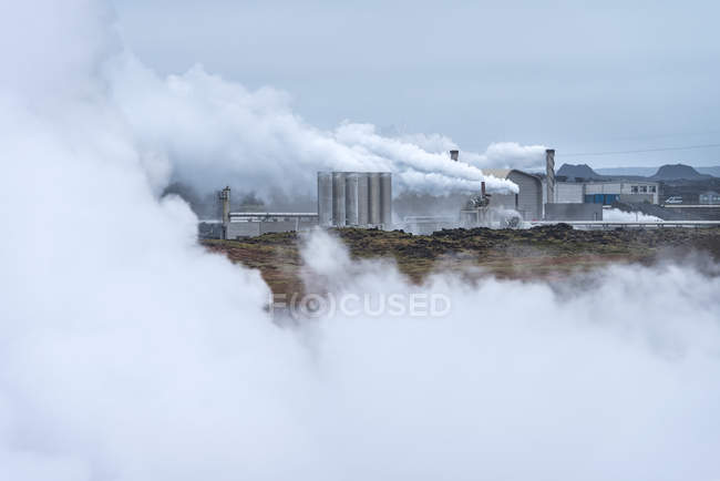 Looking across steamy, lunar landscape towards Reykjanes Power Plant; Iceland — Stock Photo