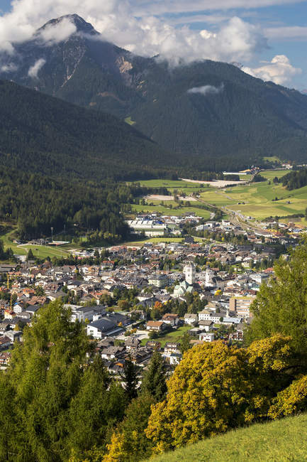 Villaggio alpino nella valle con montagne sullo sfondo; San Candido, Bolzano, Italia — Foto stock