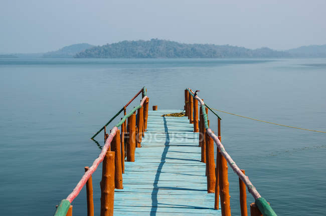 A dock leading out to the tranquil waters in the Bay of Bengal; Andaman Islands, India — Stock Photo