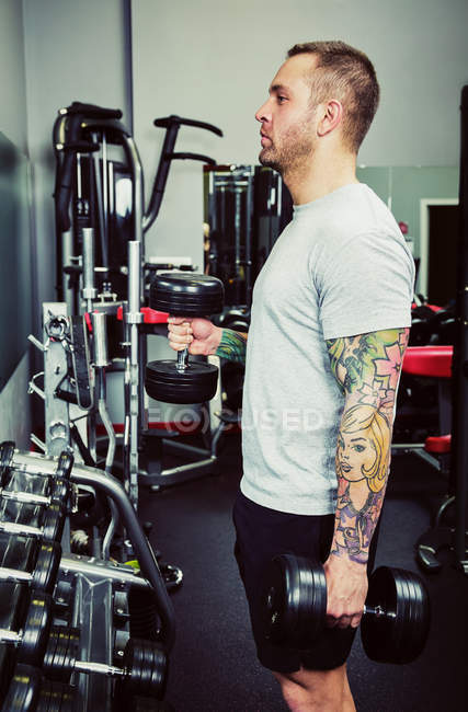 Mitte erwachsener Mann trainiert in einem Fitnessstudio — Stockfoto