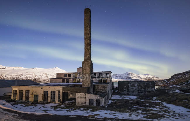Vista panorámica de la fábrica de arenques abandonada en la nieve, Djupavik, West Fjords, Islandia - foto de stock