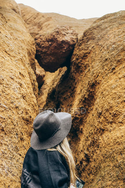 Женщина, исследующая трещину в скале, Иглз Рок, Красная Горная Тропа, Аризона, США — стоковое фото