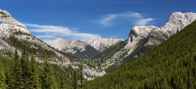 Vista panoramica sulla valle e la catena montuosa con cielo azzurro e nuvole, a sud di Canmore, Alberta, Canada — Foto stock