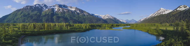 Scenic of the snow-capped Chugach Mountains reflecting in the calm water.; Anchorage, Alaska, United States of America — Stock Photo