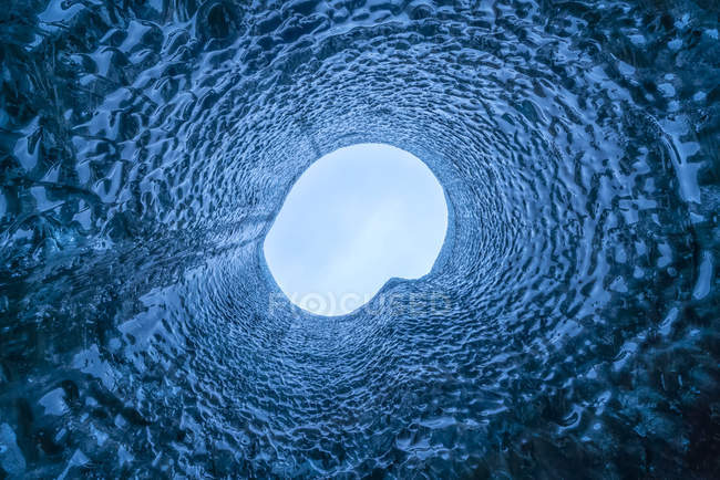 Regard droit vers le haut d'un trou dans le toit de la grotte de glace ; Islande — Photo de stock