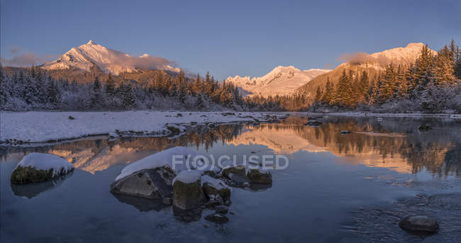 Winter sunset along the shoreline of Mendenhall River, Tongass National Forest; Juneau, Alaska, United States of America — Stock Photo