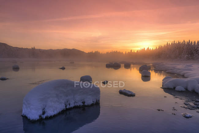 Winter sunset along the shoreline of Mendenhall River, Tongass National Forest; Juneau, Alaska, United States of America — Stock Photo