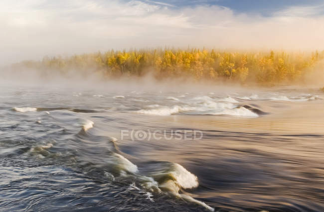 Mist over Sturgeon Falls with golden foliage on the trees in autumn, Whiteshell Provincial Park, Manitoba, Canada — Stock Photo
