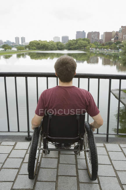 Vista trasera de un hombre discapacitado mirando a la vista - foto de stock