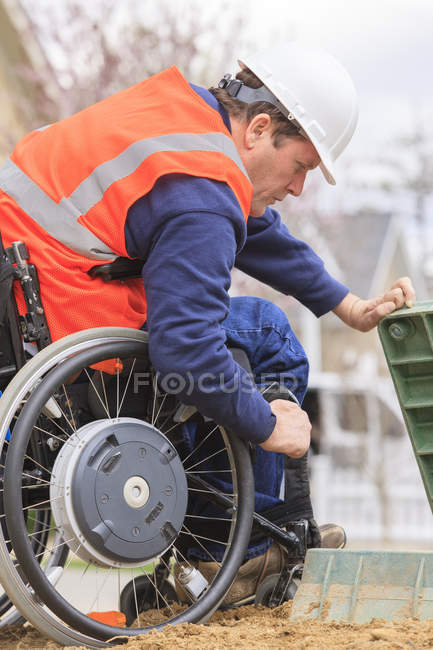Construction engineer with spinal cord injury inspecting utility box — Stock Photo