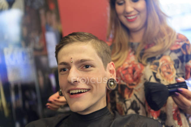 Trendy man with a spinal cord injury at a hair salon getting a hair cut — Stock Photo