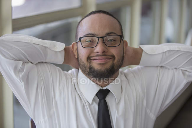 Portrait of happy African American man with Down Syndrome as a waiter in restaurant — Stock Photo