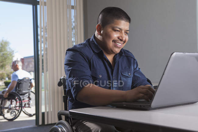 Латиноамериканець у кріслі на колесах з бесідою на роботі. — стокове фото