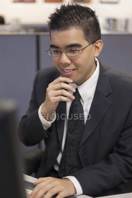 Asian man with Autism working in office — Stock Photo