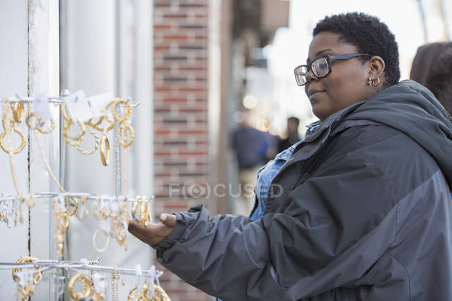 Woman with bipolar disorder shopping for jewelry — Stock Photo