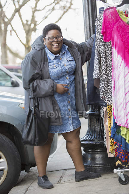 Woman with bipolar disorder shopping for clothes — Stock Photo