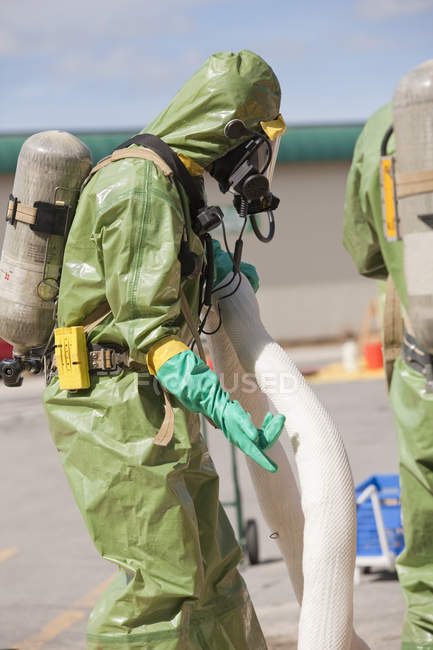 HazMat firefighter arranging chemical HazMat boom — Stock Photo