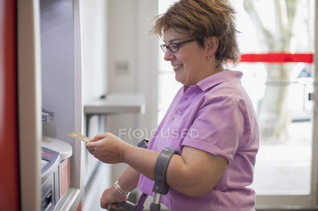 Woman with Cerebral Palsy using an ATM — Stock Photo