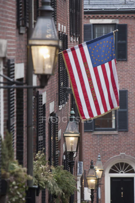 Lanterne su un muro con bandiera coloniale americana sullo sfondo, Acorn Street, Beacon Hill, Boston, Massachusetts, USA — Foto stock