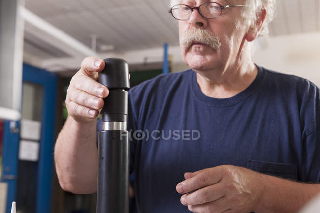 Engineer installing new membranes in an O2 electrochemical sensor probe in a laboratory — Stock Photo
