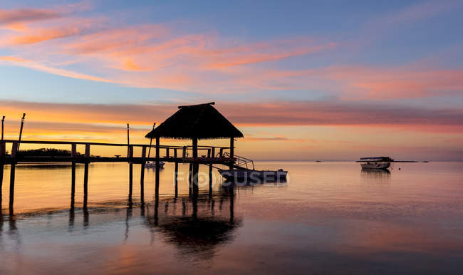 Pier off Malolo Island at sunrise into the South Pacific Ocean; Malolo Island, Fiji — Stock Photo