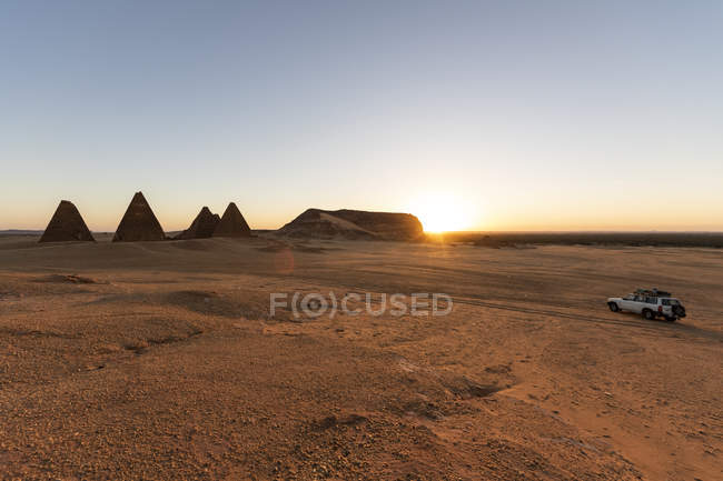 Field of Kushite royal pyramids and Mount Jebel Barkal at sunrise; Karima, Northern State, Sudan — Stock Photo