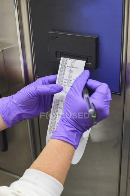 Technicien de laboratoire recueillant des données sur la stérilisation — Photo de stock