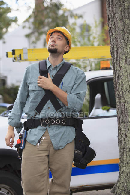 Lineman looking up for overhead wiring at site — Stock Photo