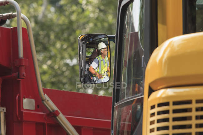 Heavy construction equipment operator in excavator — Stock Photo